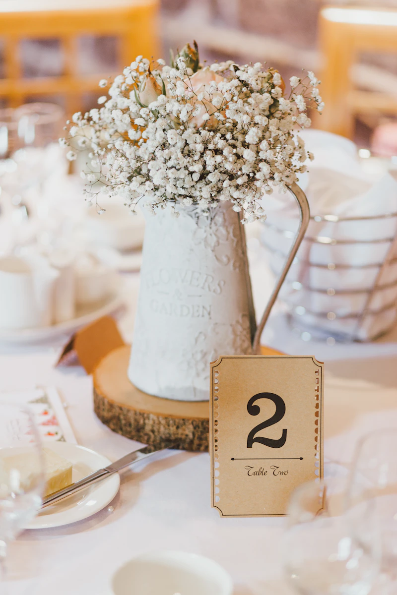 Flowers and place settings on a wedding reception table